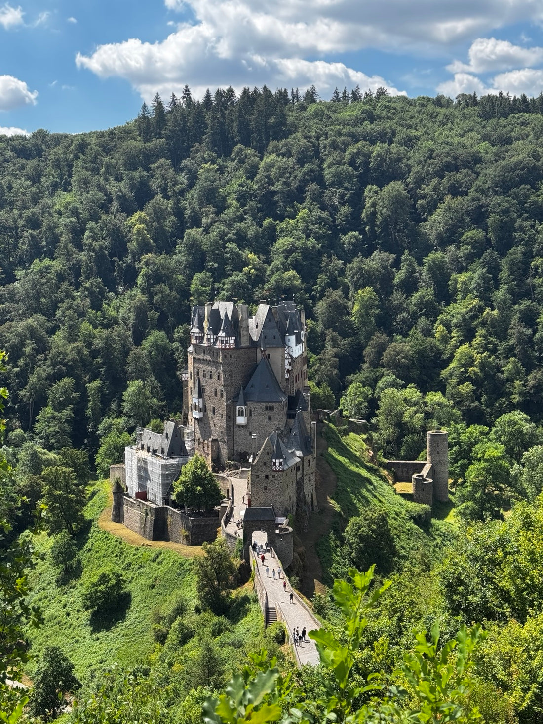 European castle surrounded by woodland on an overland touring route